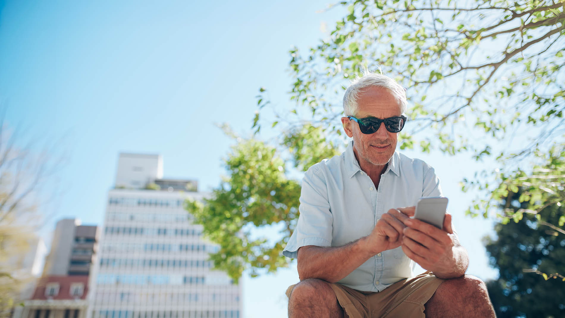 man met zonnebril op de telefoon